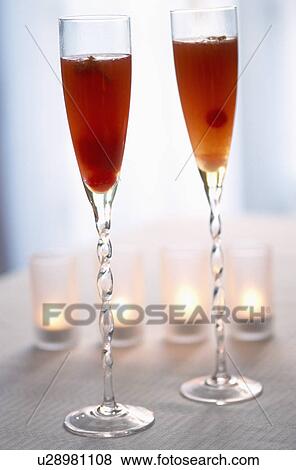 Two champagne flutes with fruit cocktails. View Large Photo Image Stock Photo - Two champagne flutes with fruit cocktails.. Fotosearch