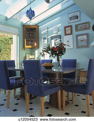 Upholstered blue tall-back chairs in modern pastel blue dining room extension View Large Photo Image Stock Image - Upholstered blue tall-back chairs in modern pastel blue dining room extension. Fotosearch