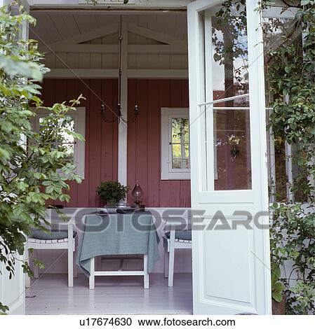 View of table and chairs inside summerhouse View Large Photo Image Stock Image - View of table and chairs inside summerhouse. Fotosearch