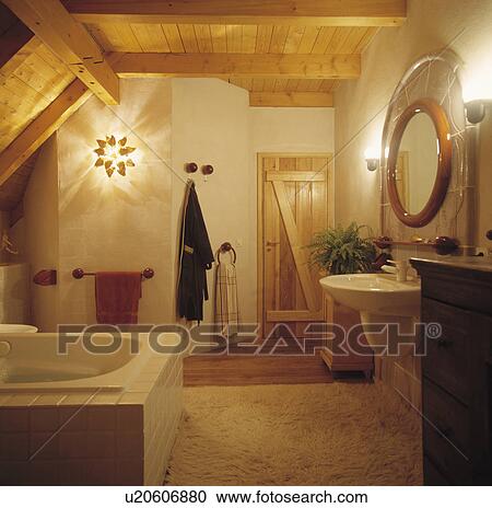 Stock Image - Wall lights in country bathroom with wooden ceiling. Fotosearch