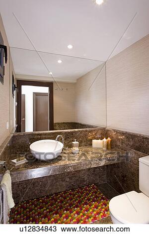 White circular basin on marble shelf below mirrored wall in small modern cloackroom View Large Photo Image Stock Image - White circular basin on marble shelf below mirrored wall in small modern cloackroom. Fotosearch