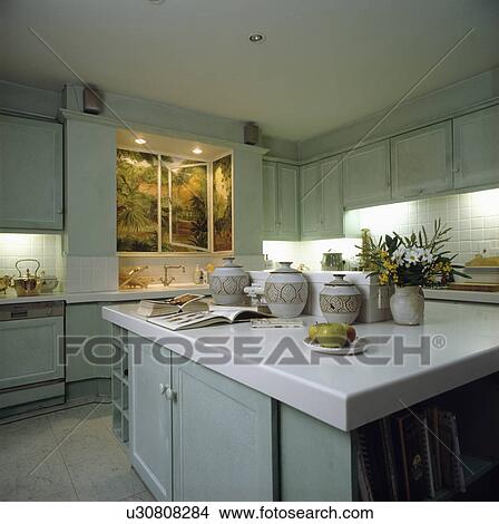 White Corian Worktop On Island Unit In Modern Grey Kitchen With