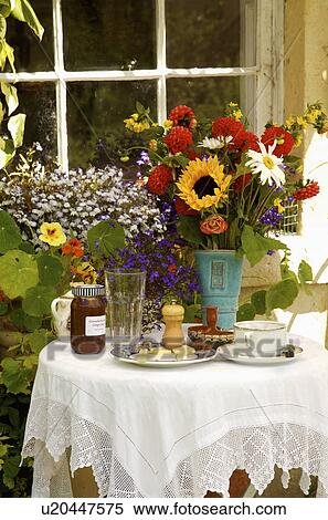 White lace cloth on table set for tea with colourful summer flowers in vase View Large Photo Image Stock Photography - White lace cloth on table set for tea with colourful summer flowers in vase. Fotosearch