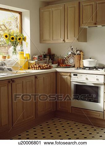 White oven in pine kitchen with yellow sunflowers on the windowsill View Large Photo Image Stock Image - White oven in pine kitchen with yellow sunflowers on the windowsill. Fotosearch