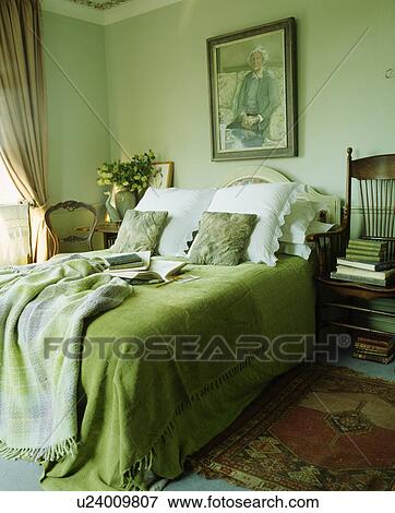 White pillows and bright green bedcover with toning checked throw on bed in pastel green bedroom View Large Photo Image Stock Photo - White pillows and bright green bedcover with toning checked throw on bed in pastel green bedroom. Fotosearch