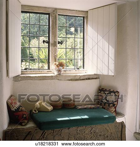 White shutters on casement window above telephone and windowseat in cottage hall View Large Photo Image Stock Image - White shutters on casement window above telephone and windowseat in cottage hall. Fotosearch