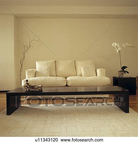 White sofa and low black table in uncluttered modern living room View Large Photo Image Stock Image - White sofa and low black table in uncluttered modern living room. Fotosearch