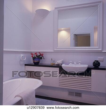 White tiled architectural bathroom with built in basin and storage. View Large Photo Image Stock Photo - White tiled architectural bathroom with built in basin and storage.. Fotosearch