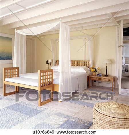 White Voile Curtains And Linen On Modern Four Poster Bed With White Voile Curtains And Linen On