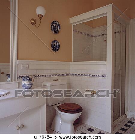 White wall tiles and toilet beside shower cabinet in modern neutral bathroom View Large Photo Image Stock Photography - White wall tiles and toilet beside shower cabinet in modern neutral bathroom. Fotosearch