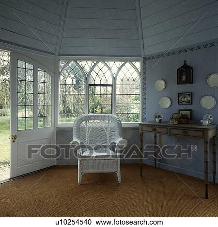 White wicker armchair in front of Gothic-style window in pastel blue hall with sisal carpet and wooden ceiling View Large Photo Image Stock Image - White wicker armchair in front of Gothic-style window in pastel blue hall with sisal carpet and wooden ceiling. Fotosearch