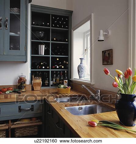 Wine stored in cube shelving above wooden kitchen worktop with underset double stainless steel sinks View Large Photo Image Stock Image - Wine stored in cube shelving above wooden kitchen worktop with underset double stainless steel sinks. Fotosearch