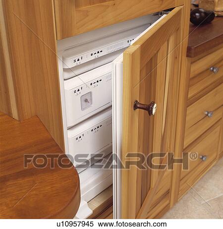Wood kitchen cupboard with door open to reveal freezer View Large Photo Image Stock Photography - Wood kitchen cupboard with door open to reveal freezer. Fotosearch