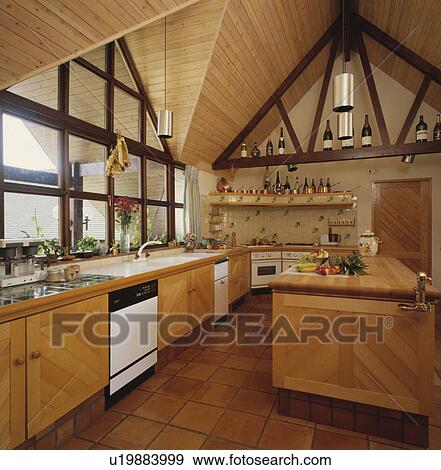 Wooden Apex Ceiling In Modern Pale Wood Kitchen With Terracotta
