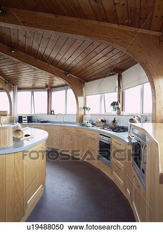 Wooden ceiling in circular pale wood modern kitchen with slate flooring View Large Photo Image Stock Image - Wooden ceiling in circular pale wood modern kitchen with slate flooring. Fotosearch