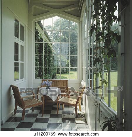 Wooden chairs in traditional conservatory View Large Photo Image Stock Photo - Wooden chairs in traditional conservatory. Fotosearch