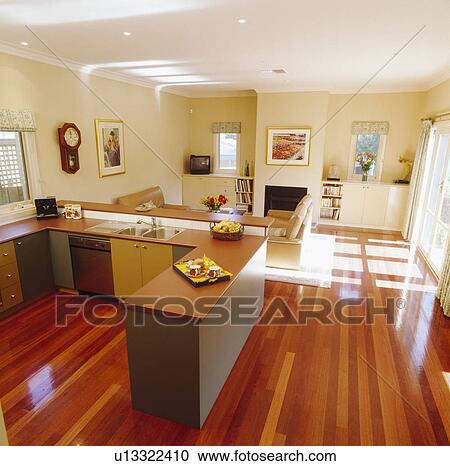 Stock Image - Wooden flooring in modern openplan kitchen and living room. Fotosearch