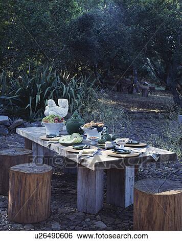 Wooden furniture on patio in country garden in summer View Large Photo Image Stock Photograph - Wooden furniture on patio in country garden in summer. Fotosearch