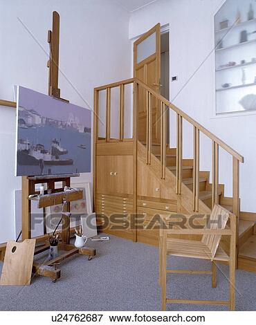 Wooden staircase with understairs storage cupboards and drawers in studio with easel and wooden chair View Large Photo Image Stock Photo - Wooden staircase with understairs storage cupboards and drawers in studio with easel and wooden chair. Fotosearch