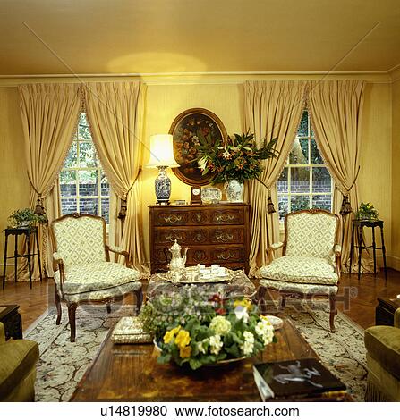 Yellow curtains and cream chairs in traditional yellow living room View Large Photo Image Stock Image - Yellow curtains and cream chairs in traditional yellow living room. Fotosearch