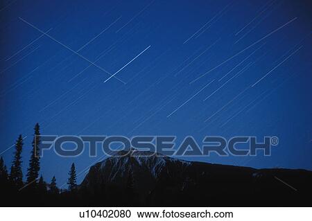 abstract star trails over snowy peaks canadian View Large Photo Image Stock Image - abstract star trails over snowy peaks canadian. Fotosearch