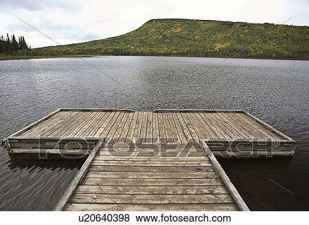 Stock Photo -  art boat dock musreau lake fall autumn leaves. Fotosearch
