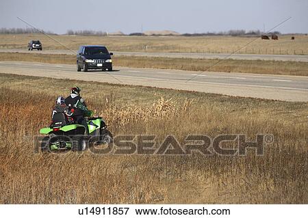 Stock Photo -  atv in ditch trans canada highway all terrain. Fotosearch