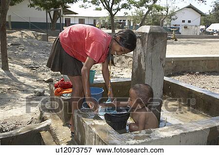 baby water people girl timor leste camp for idps View Large Photo Image Stock Photo - baby water people girl timor leste camp for idps. Fotosearch