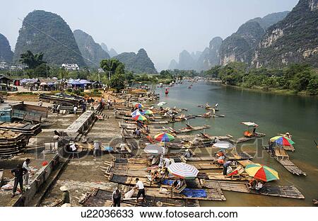Stock Image -  bamboo tourist rafts pulled out yulang river . Fotosearch