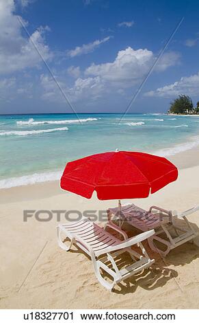 Stock Image -  beach beautiful red umbrella chair in front. Fotosearch