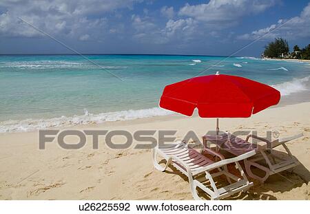Stock Image -  beach beautiful red umbrella chair in front. Fotosearch