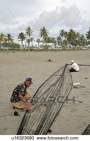 Stock Image -  beach people person indonesia fishermen nets . Fotosearch
