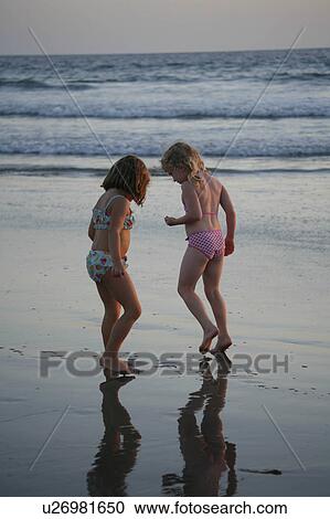 Stock Image -  beach water pattern children reflection girls . Fotosearch
