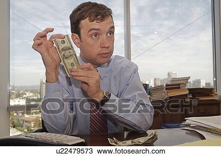 business money office man sitting behind desk View Large Photo Image Stock Image - business money office man sitting behind desk . Fotosearch