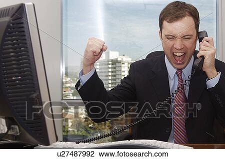 Stock Image -  business office man in uses phone screams pumps. Fotosearch