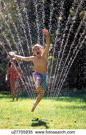 Stock Photography -  child 7-9 years arms raised boy carefree cheerful. Fotosearch