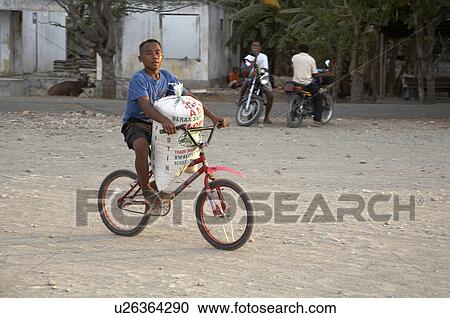 Stock Image -  child children kid timor leste boy carrying sack. Fotosearch