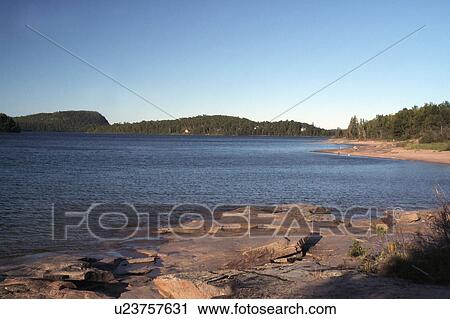 Stock Image -  clear superior morning lake ontario canada rocky. Fotosearch