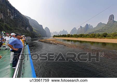 Stock Photo -  cruising lijiang river guanxi china admiring. Fotosearch