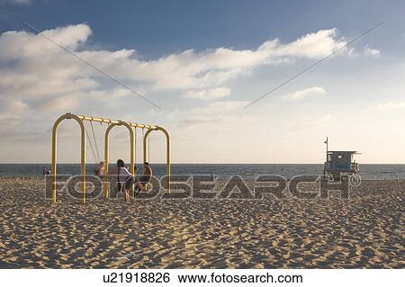 Stock Photograph -  family woman beach child children pushing mr usa. Fotosearch