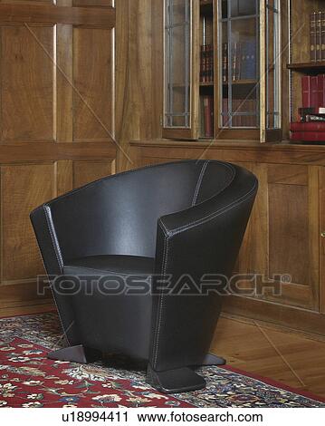 Stock Image -  fashion design house armchair library wood wall . Fotosearch
