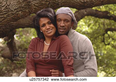 Stock Image -  fashion love summer couple holding hands sitting . Fotosearch