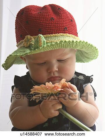 Stock Photo -  flower baby child children fancy hat playing toy. Fotosearch