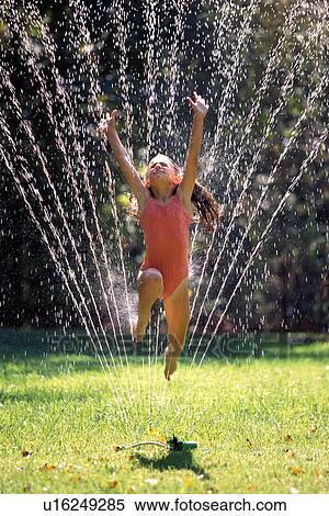 girl child 7-9 years arms raised bathing suit View Large Photo Image Stock Photography - girl child 7-9 years arms raised bathing suit. Fotosearch