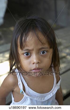 Stock Photo - girl child timor leste camp for internally displaced. Fotosearch