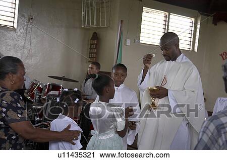 Stock Image -  jamaica communion given father carl clark sunday. Fotosearch