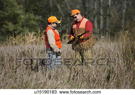 man father son standing in field looking shotgun View Large Photo Image Stock Image - man father son standing in field looking shotgun . Fotosearch