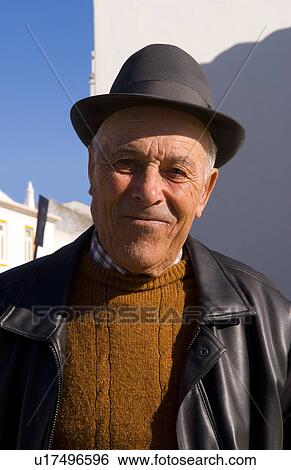 Stock Photograph -  man local in hat church beautiful algarve vila . Fotosearch