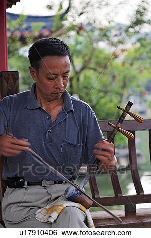 Stock Photograph -  man male playing chinese opera fiddle in park man . Fotosearch