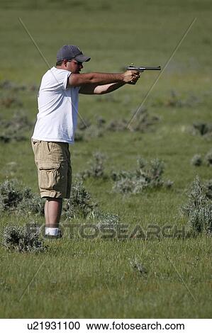 man male shooting 22 cal pistol hunter handgun View Large Photo Image Stock Image - man male shooting 22 cal pistol hunter handgun . Fotosearch